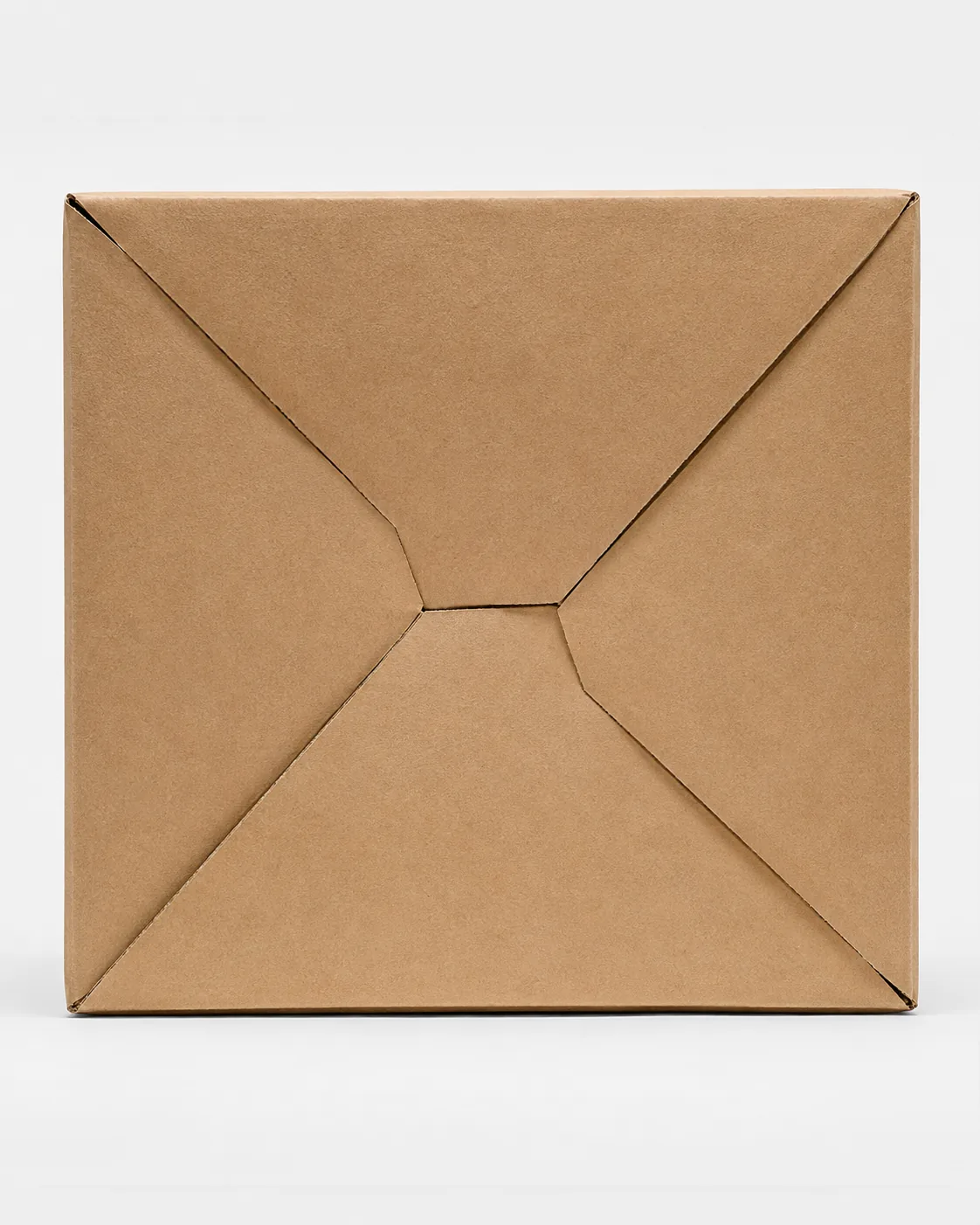 The underside of a kraft carton with its crash lock base closed, the four panels folded into each other and sitting flat.