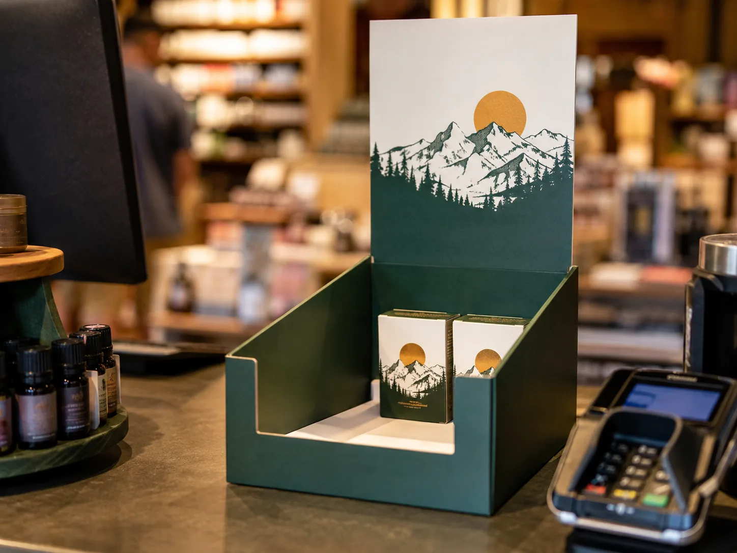 A counter display down to its last two cartons on a shop counter, the walls still square and the printed header still standing straight.