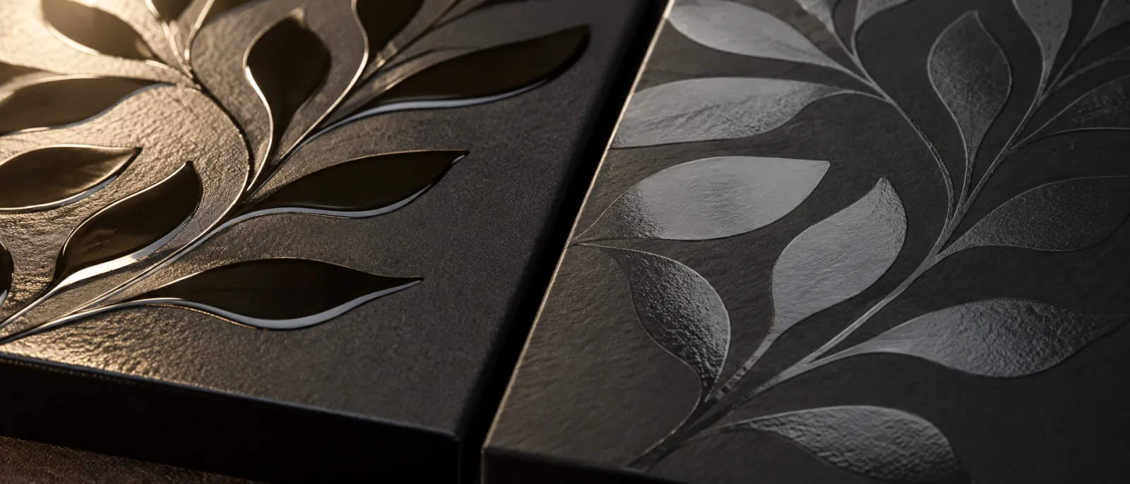 The same botanical across one dark panel twice: raised varnish on the left half standing proud enough to throw its own shadow, and the flatter pass on the right sitting level with the board and reading only as a change in sheen.
