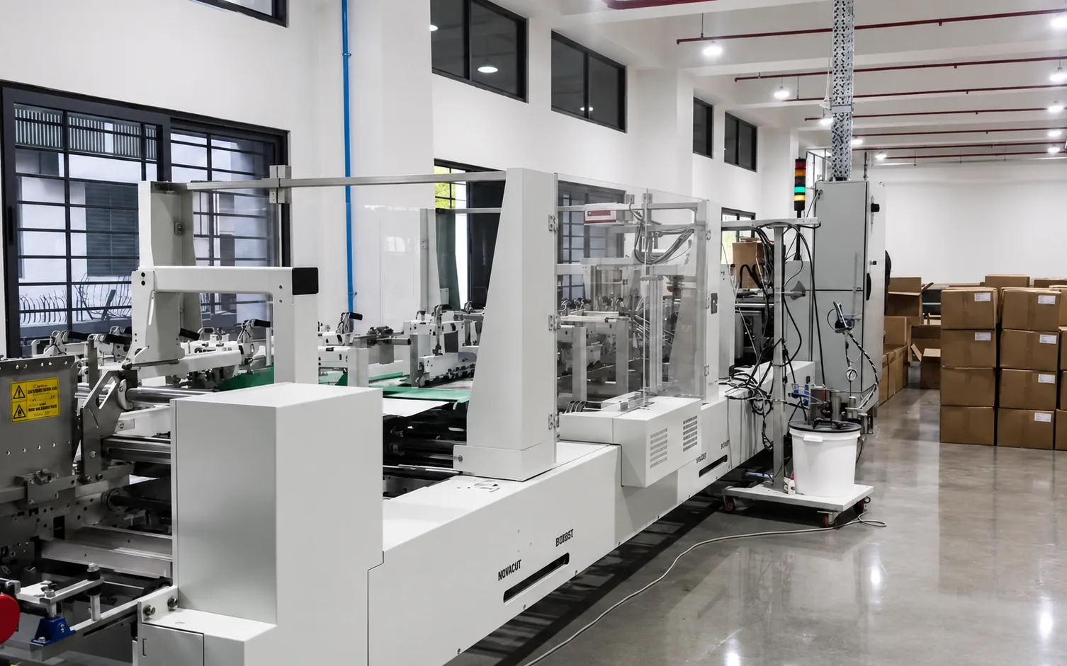 The folding section of the Bobst Novafold closing cartons along the line