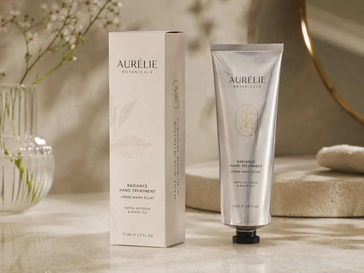 A tall reverse tuck end carton standing beside the aluminum hand cream tube it was built around, on a pale counter.