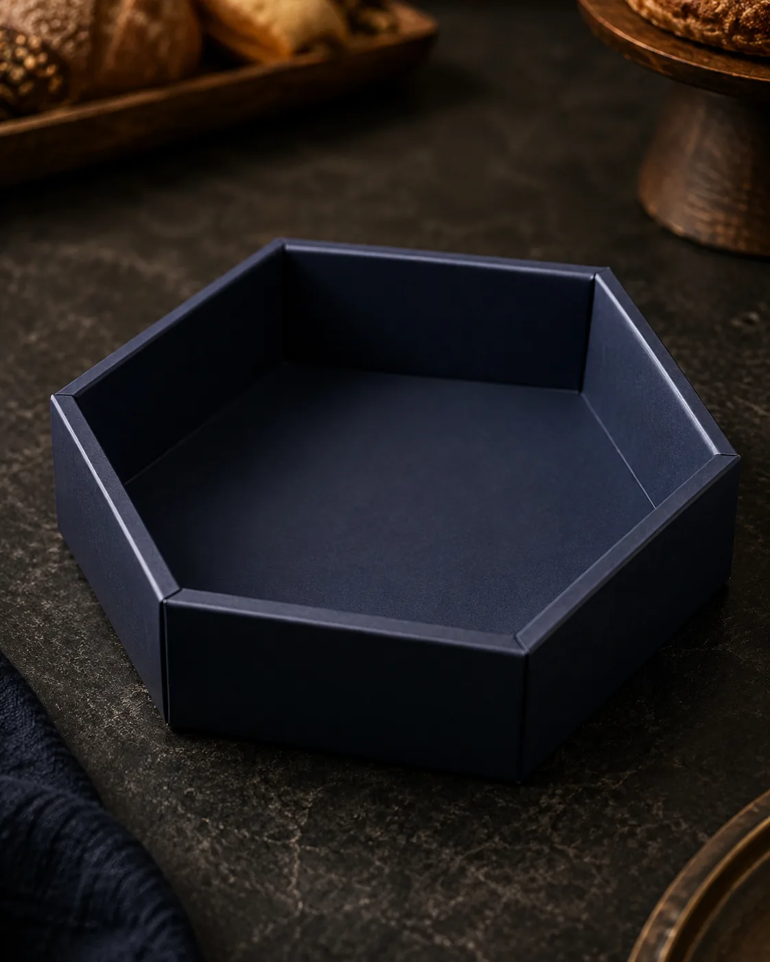 A navy six corner tray closed and squared on a dark counter, the doubled board reading as a thicker rim along the end walls.