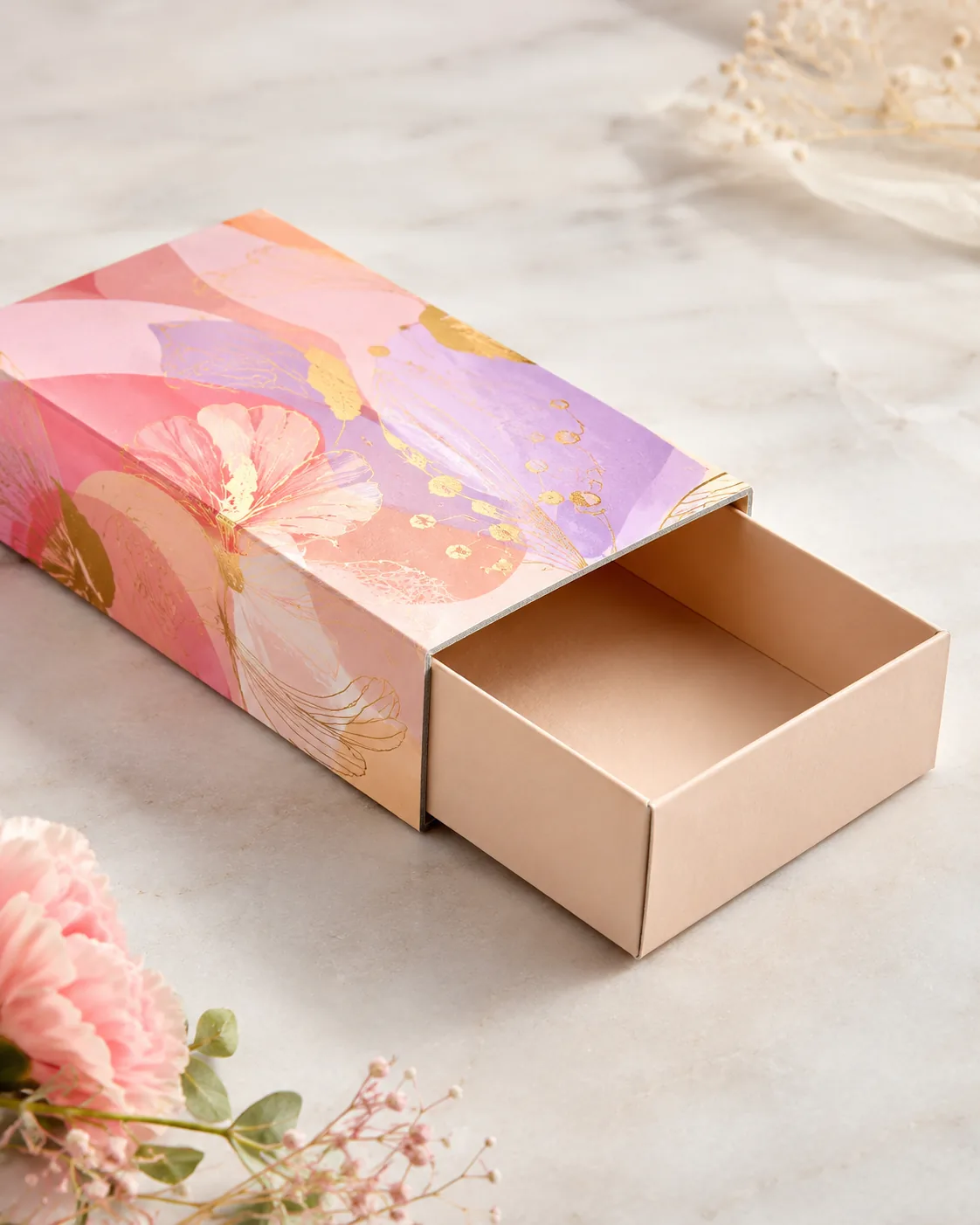A printed sleeve slid halfway back off a plain inner tray on a pale ground, the board thickness of the sleeve reading along its open edge