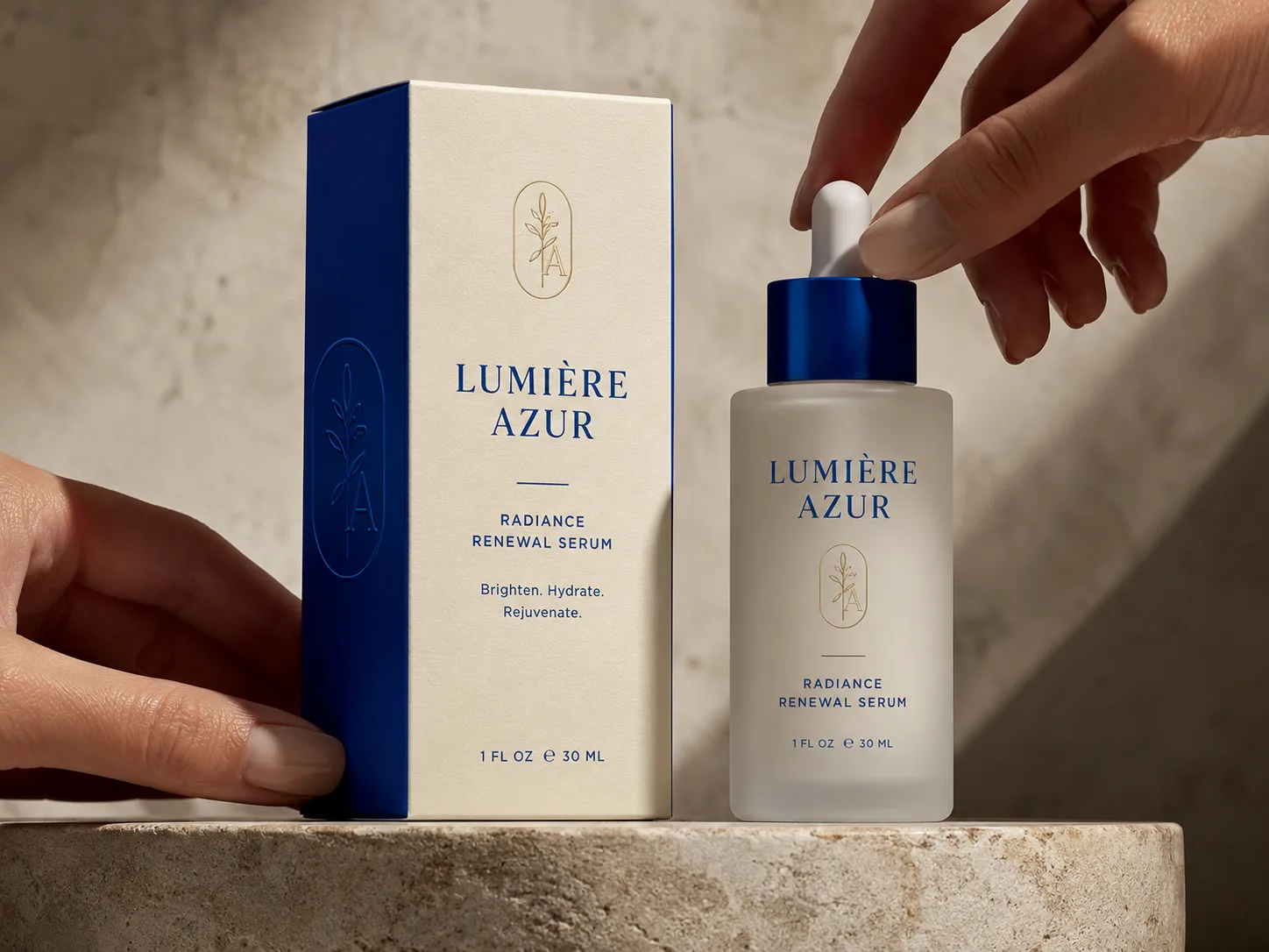 A cream and blue serum carton held to camera, the frosted dropper bottle it holds standing beside it.