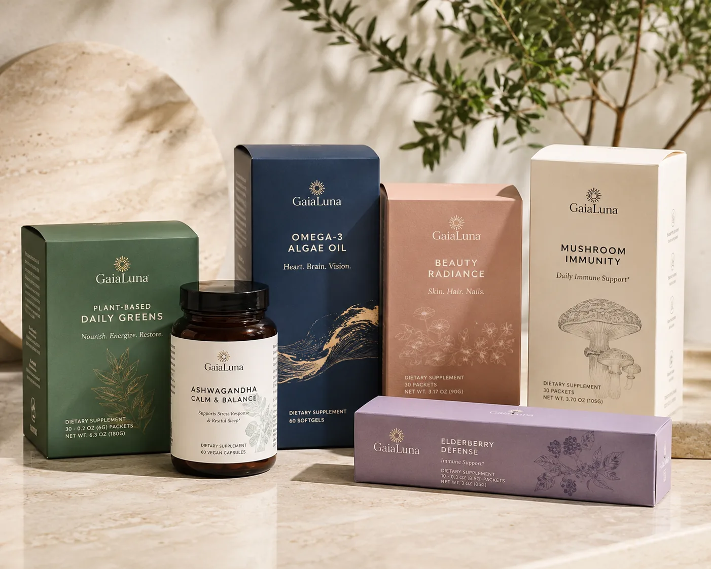 Six supplement cartons in one livery on a marble surface: a greens carton, an omega carton, a beauty carton, a mushroom carton, an elderberry sleeve and a capsule bottle